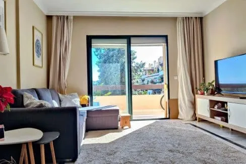 Living room with dark grey sofa, shaggy rug – apartment for rent, Las Terrazas de Bel Air, Estepona