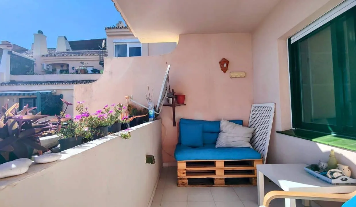 Terrasse avec banquette en palettes à coussins bleus et fleurs – appartement à louer, Las Terrazas de Bel Air, Estepona