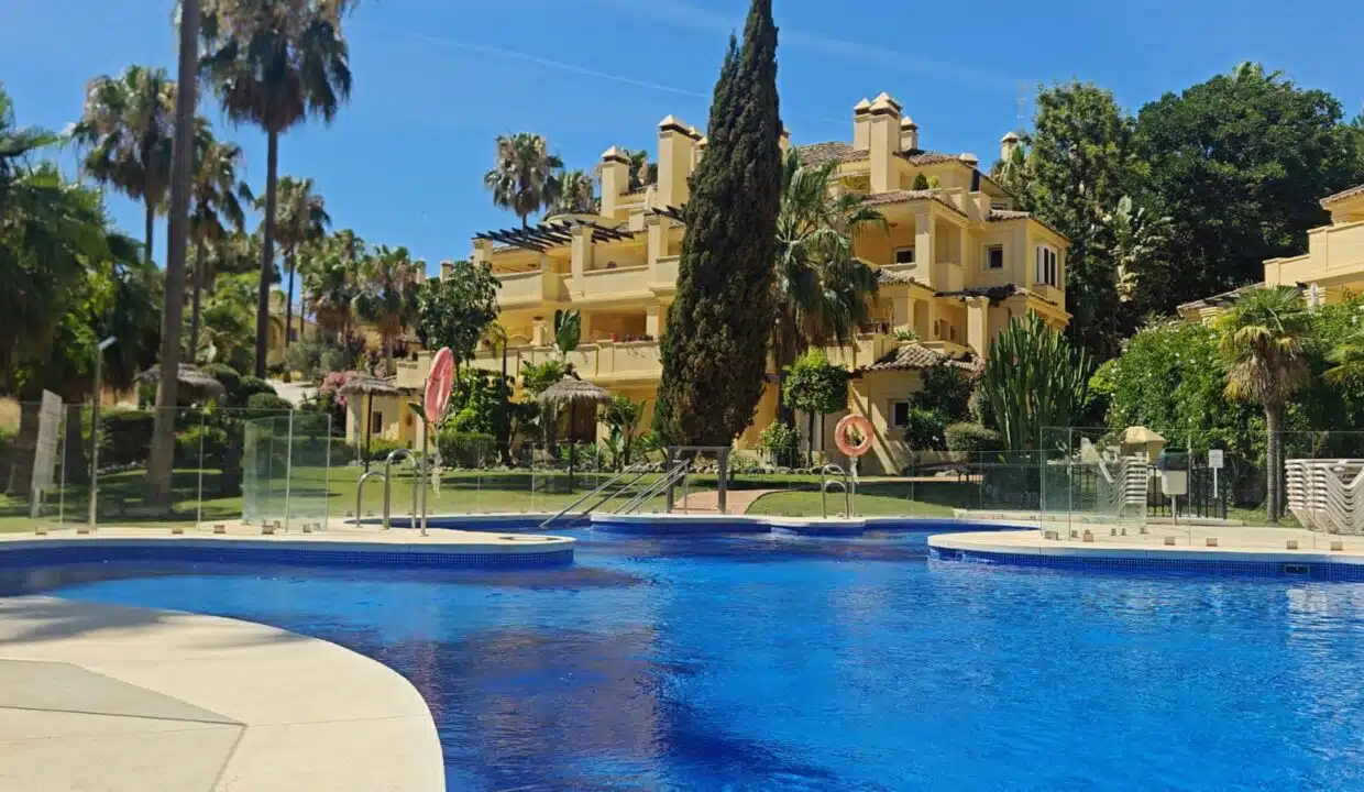 Piscina azul frente a los edificios amarillos – apartamento en alquiler, Majestic Hills, Casares (ref. AL014)