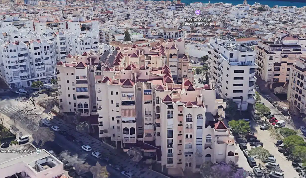 Aerial view of a beige building with red roofs near Estepona old quarter – apartment for rent, Estepona town centre
