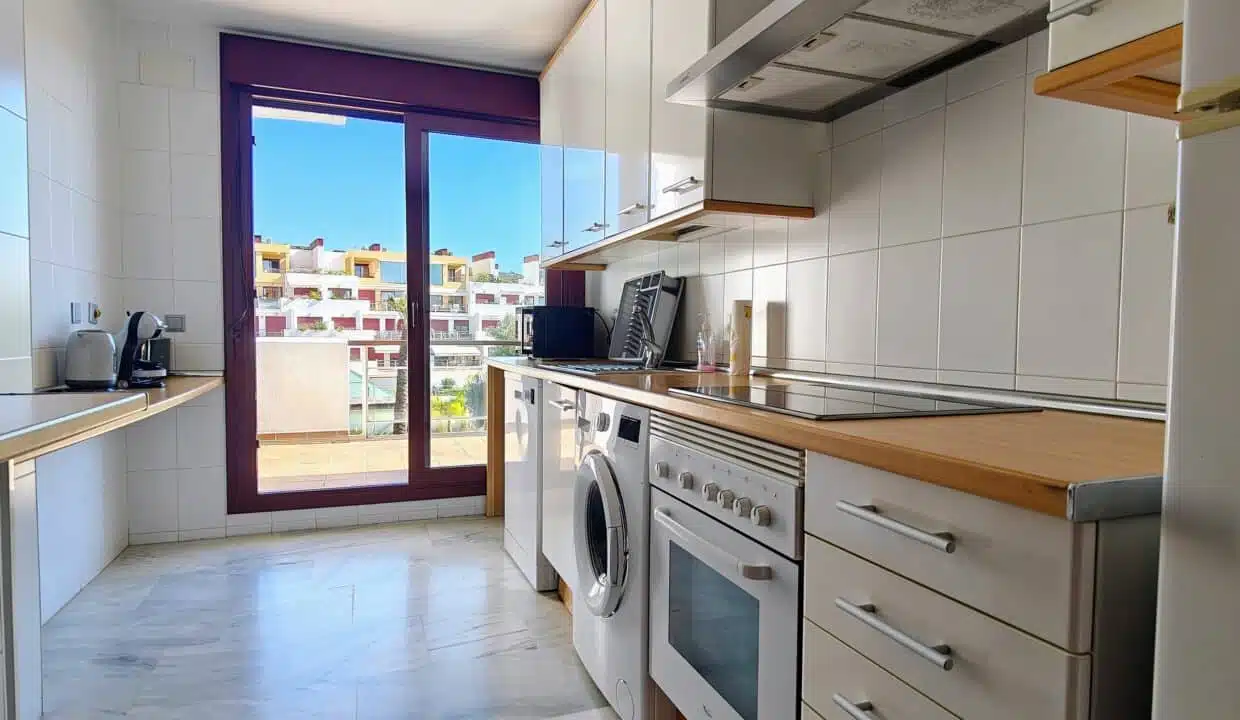 Cuisine à plan de travail en bois, lave-linge et porte-fenêtre – appartement à louer, Parque Botanico, Benahavís (réf. AL035)
