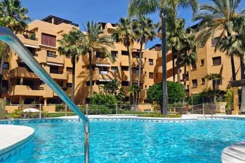Residence pool surrounded by palm trees – apartment for rent, Terrazas de Costalita, Estepona (ref. AL037)