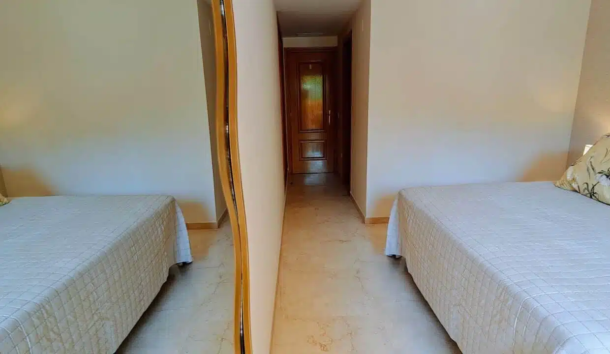 Bedroom with white quilted bedspread and floral cushions – apartment for rent, Terrazas de Costalita, Estepona (ref. AL037)