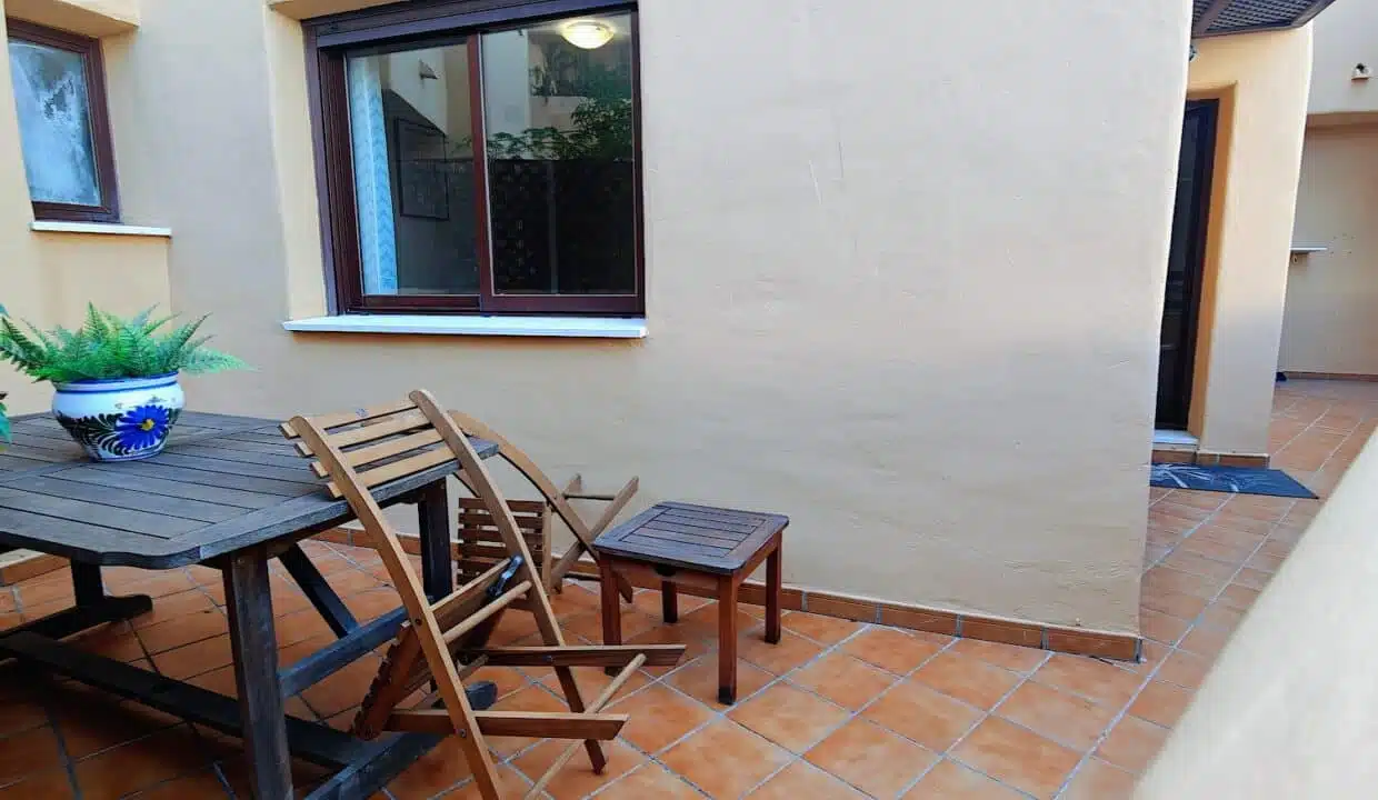 Patio with wooden table and folding chairs – apartment for rent, Terrazas de Costalita, Estepona (ref. AL037)