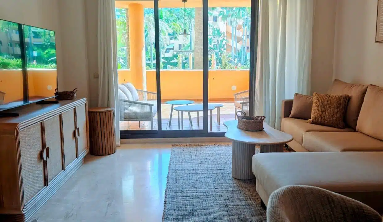 Living room with sliding door to an orange-walled balcony – apartment for rent, Terrazas de Costalita, Estepona (ref. AL037)