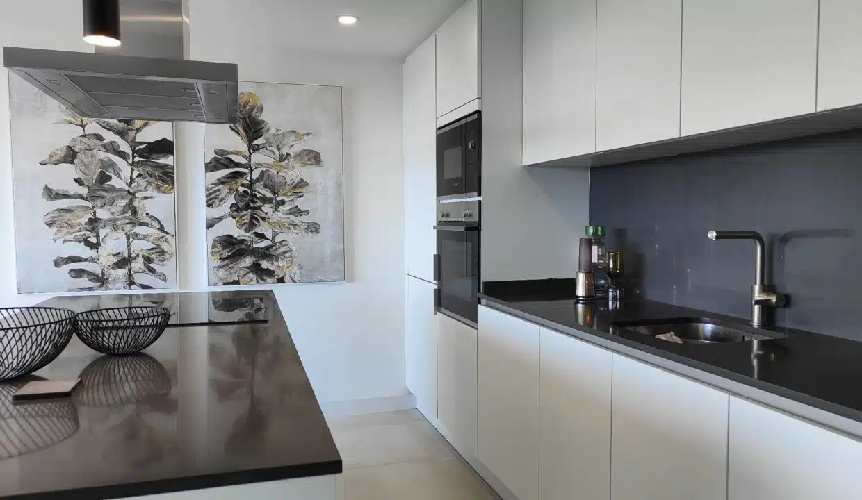 Cuisine blanche sans poignées, plan noir, évier – appartement à louer, Oasis 325, Estepona (réf. SUM038)
