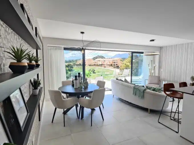 Dining area with cream chairs, plant shelves – apartment for rent, Oasis 325, Estepona (ref. SUM038)