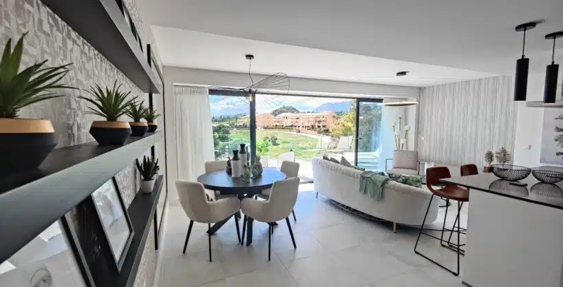 Dining area with cream chairs, plant shelves – apartment for rent, Oasis 325, Estepona (ref. SUM038)